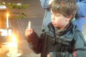 Boy lighting candle